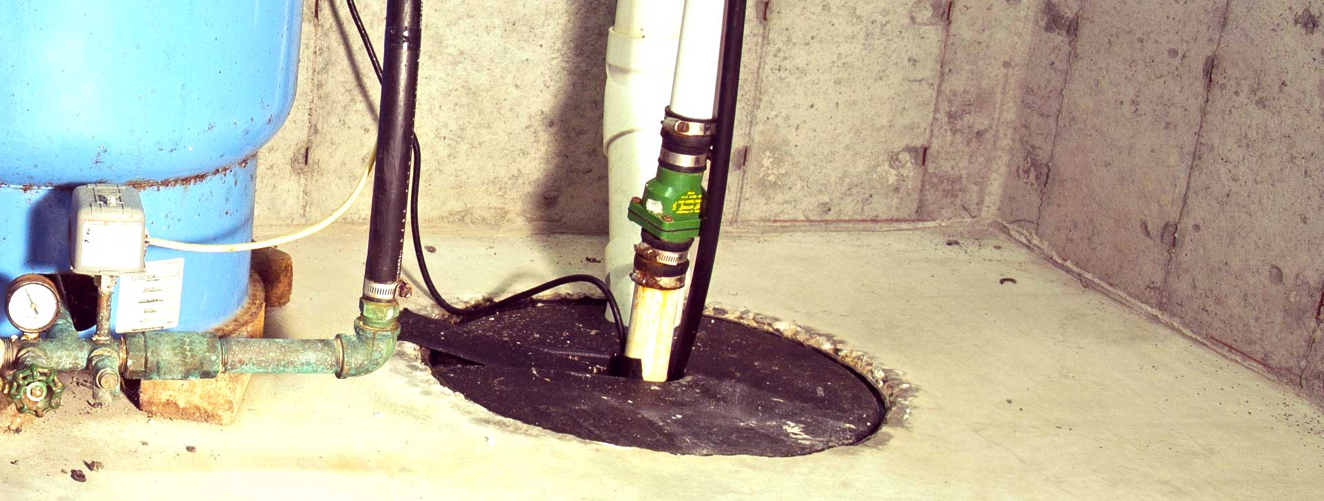 a sump pit visible in the basement of a toronto area home, discharge pipe is visible extending from the top of the sump pit lid